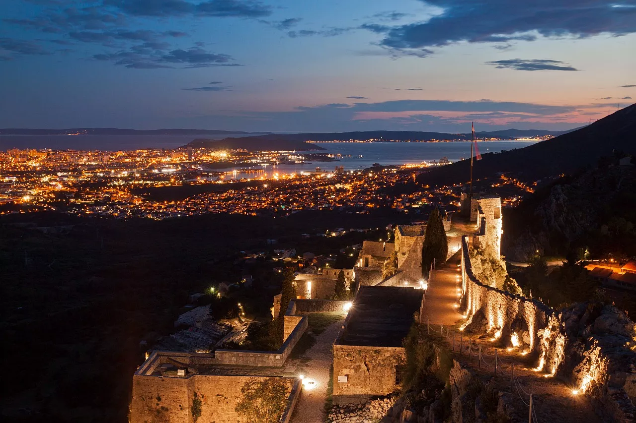 Klis Fortress at sunset. City of Split in the background - Croatia